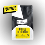 Black and yellow coffee package with 'Perky Blenders' branding on a gray background
